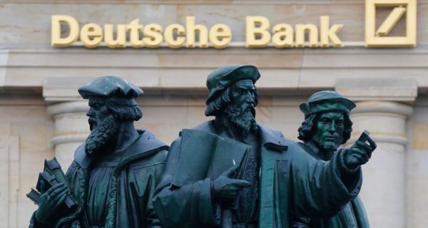 Deutsche Bank said it would lower its 2012 pretax profit  after it was hit by new charges related to mortgage-related lawsuits. Photograph: Kai Pfaffenbach/Reuters.