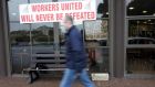 A man walks past the Waterford Crystal visitors centre during a protest in 2009.   Photograph: Eric Luke / The Irish Times