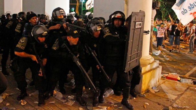 Police take up position against demonstrators in Belem.The protests come one month before Pope Francis is scheduled to visit Brazil, and ahead of the 2014 World Cup and 2016 Olympics, raising concerns about how Brazilian officials will provide security.  Photograph: Ney Macondes/Reuters

