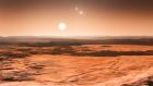 An artist’s impression of the view from one of planets orbiting the star Gliese 667C. The planet’s sun can be seen together with two more distant stars in the triple system. To the left, one of the other newly discovered planets appears as a crescent. Photograph: ESO/M. Kornmesser/PA Wire