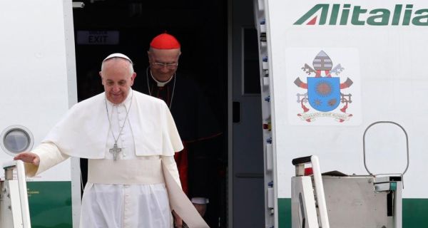 Pope Francis (front) and Cardinal Tarcisio Bertone step off a plane after returning from their trip to Brazil at Ciampino airport, south of Rome, today. Photograph: Reuters 