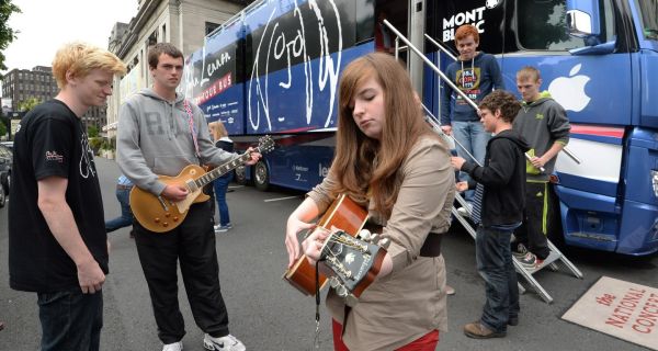 Music students from Dundalk Youth Centre taking part in a workshop on the John Lennon Music Mobile an Education Tour Bus. Engineer Jamie Thompson, Conor Loughnan and Kate Rogers play outside the bus at the National Concert Hall today. Photograph: Cyril Byrne/The Irish Times