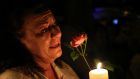 A women cries as she holds a candle and a flower outside former   South African President Nelson Mandela's house in Houghton, last night.   Photograph: Siphiwe Sibeko/Reuters.
