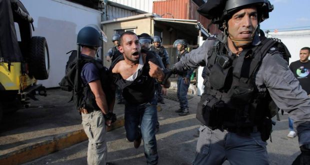 Israeli police detain a protester during Monday’s protest by Israeli Arabs in Nazareth against the Gaza offensive. Photograph: Reuters/Ammar Awad 