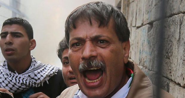 A file picture from  November 2014 showing  Palestinian Authority minister  Ziad Abu Ein shouting towards Israeli soldiers from behind a fence on the Palestinian side of the divided West Bank city of Hebron. According to media reports he was reportedly killed during a confrontation with Israeli soldiers. Photograph: EPA 