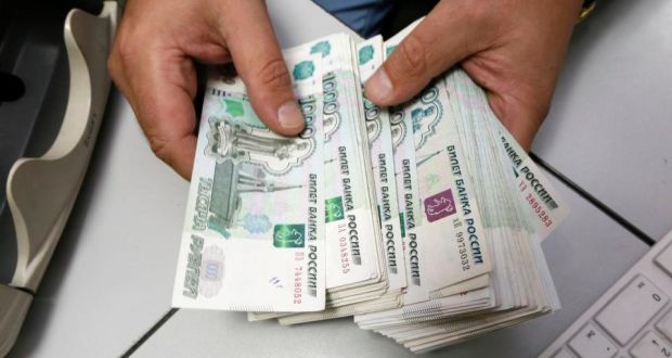 An employee counts Russian ruble banknotes at a private company’s office in Krasnoyarsk, Siberia. Photograph: Ilya Naymushin/Reuters