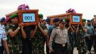  Indonesian soldiers carry coffins containing victims of the AirAsia flight QZ8501 crash at the Indonesian Air Force Military Base Operation Airport  in Surabaya. Photograph: Robertus Pudyanto/Getty Images.
