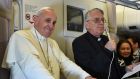 Pope Francis (left) flanked by Padre Federico Lombardi speak to journalist  onboard a plane during his trip back to Rome, on Monday  from the Philippines. Photograph: Getty 