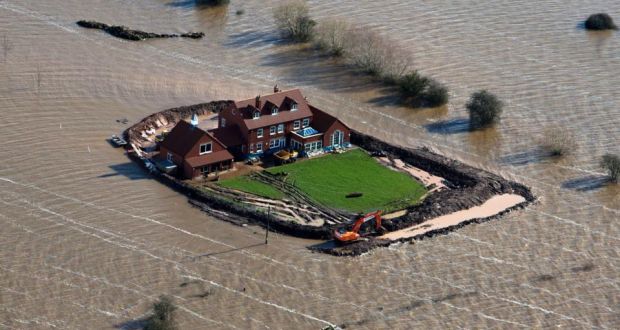 Not so warm: ‘climate chaos’ might be better at capturing some of the urgency needed. Above, a house near the flooded village of Moorland in Somerset last year. Photograph: Steve Parsons/PA Wire