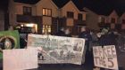 Protesters hold a banner outside the home of Ray Butler TD on Monday. Photograph: Tomás Allen Meath 1916 Society/Facebook