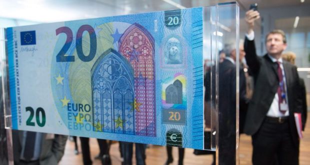 A man takes a photo of the new 20 euro note during its presentation. ECB President Mario Draghi during the presentation signed the over-sized sample of the note that shows a new design and includes additional security features. It will be in  circulation from 25th November 2015. EPA/BORIS ROESSLER