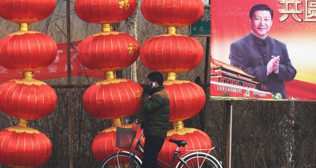 A man walks past a billboard featuring a photo of China’s president Xi Jinping beside lantern decorations for the Lunar New Year in Baoding, China’s northern Hebei province, on Tuesday. Mr Xi has unveiled his latest political slogan, the “Four Comprehensives”, a call for a more prosperous country and deeper reform. Photograph: Greg Baker/AFP/Getty Images