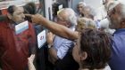 Pensioners waiting outside a closed National Bank branch and hoping to get their pensions, argue with a bank employee in Iraklio in Crete. Photograph: Stefanos Rapanis/Reuters