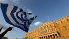 A protester waves a Greek flag during an anti-austerity rally in Athens, Greece. Photograph: Yannis Behrakis/Reuters