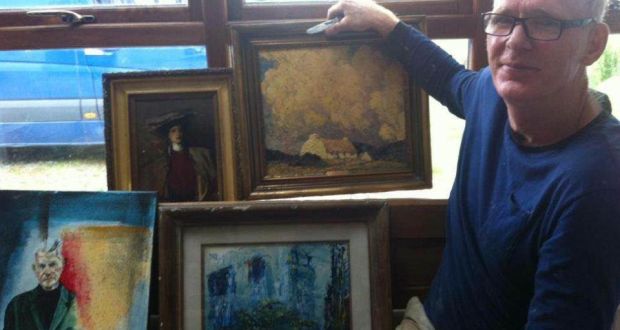 Denis Russell  shows the paintings he found in a hedge near his home in Co Wicklow on Tuesday. Photograph: Whelan family 
