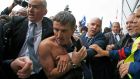 A shirtless Xavier Broseta, an Air France executive, is evacuated by security after employees interrupted a meeting at the Air France headquarters on Monday.  Photograph: Jacky Naegelen/Reuters
