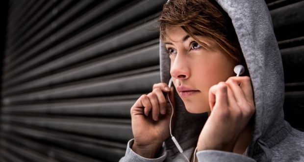Headphones in, hoody up: people’s behaviour is influenced by the way cities are designed. Photograph: E+/Getty 