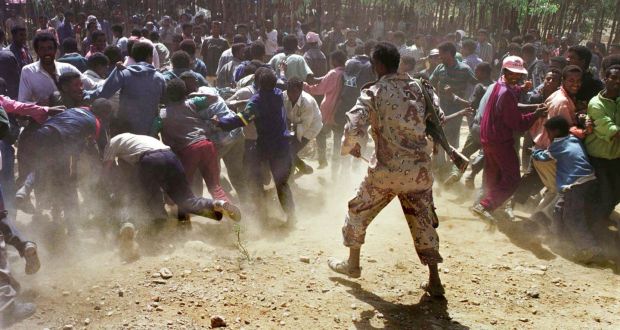 An Eritrean soldier beats back a crowd of Ethiopian detainees at a camp in Sheketi, Eritrea in June 2000. The  two-year war brought about a disastrous loss of life – 70,000-100,000 people are estimated to have died in scenes of modern trench warfare. Photograph: Tyler Hicks/Liaison