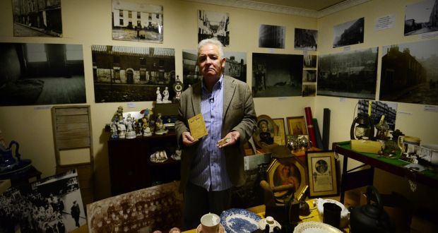 Terry Fagan of the North Inner City Folklore Project with some of the items stored in a boarded up flat in Sean McDermott Street. Photograph: Bryan O’Brien