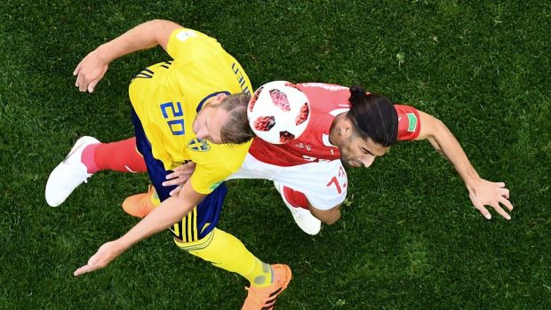   The Sweden's Ola Toivonen rivals Switzerland's Ricardo Rodriguez in World Cup match at Saint Petersburg stadium Photo: Jewel Samad / AFP / Getty Images 