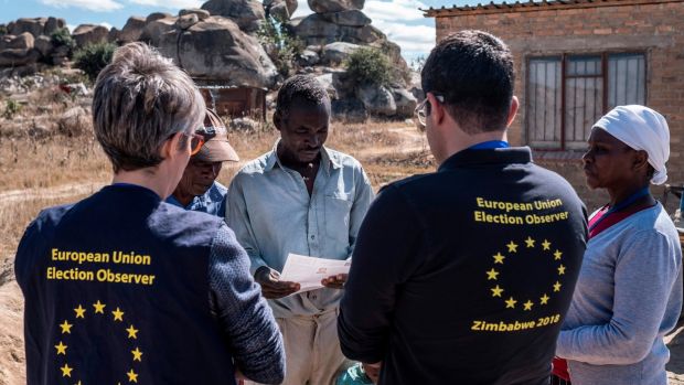   Members of an EU Election Observation Team Speak to Electors in Nyatsime, Zimbabwe Photo: Marco Longari / AFP / Getty Images 
