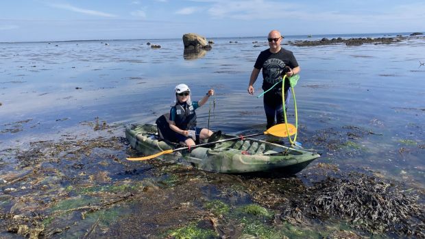 Mick Berry of Coastwatch campaign team and his son Shem after paddling around the extensive seagrass bed at Kilmore quay in Co Wexford