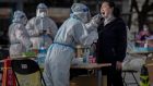 A local resident is tested at a mass testing site in Beijing as China steps up efforts to control a surge in Covid-19 cases. Researchers have found Covid-19 increases the risk of clotting. Photograph: Kevin Frayer/Getty Images