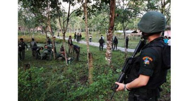 Security personnel investigate after after a Muslim insurgent attack on an army base in the troubled southern province of Narathiwat in Thailand earlier today. Photograph: Surapan Boonthanom/Reuters