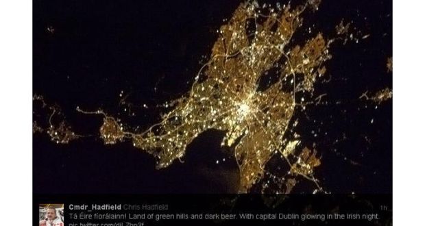 Night-time photograph of Dublin taken by Canadian Cmdr Chris Hadfield from the International Space Station and his tweet in Irish.
