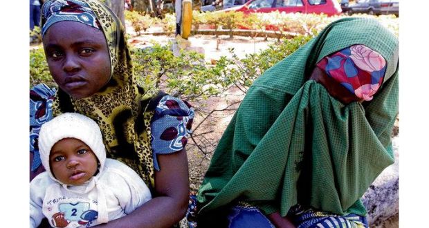 Hauwa Ahmed, right, cries after losing her son to violence in Jos, Nigeria, yesterday. Photograph: (AP Photo/Sunday Alamba)
