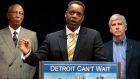 Kevyn Orr addresses the media, as Detroit Mayor Dave Bing (l) listens, after Michigan Governor Rick Snyder (r) announced Mr Orr as emergency financial manager for the city of Detroit. Photograph: Rebecca Cook/Reuters