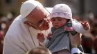Pope Francis kisses 8-month-old Victoria Maria Marino from Sicily after delivering his blessing to the palms and to the faithful in St Peter's Square during Palm Sunday Mass last Sunday. Photograph: Dan Kitwood/Getty Images 