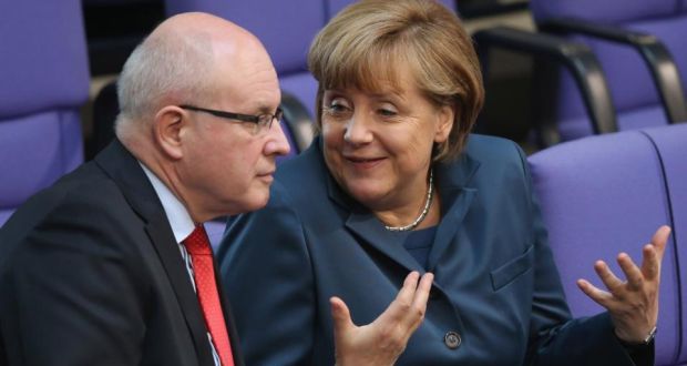 German chancellor Angela Merkel speaks to Volker Kauder, chairman of the CDU/CSU parliamentary group in the Bundestag, prior to debates over EU finanical aid to Cyprus at the Bundestag on Thursday. Photograph: Sean Gallup/Getty Images