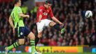 Manchester United’s Robin van Persie (right) scores his team’s second goal in a 3-0 win over Aston Villa at Old Trafford to caim a 20th league title. Photograph: Martin Rickett/PA Wire.  