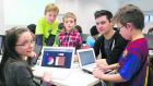 CoderDojo founder James Whelton with some young learners at a CoderDojo event