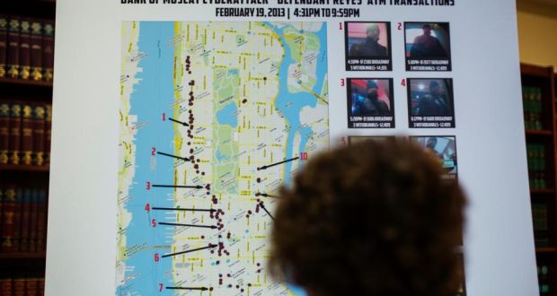 A woman looks at a map showing where eight members belonging to a New York-based cell of a global cyber criminal organization withdrew money from ATM machines, during a news conference in New York. Photograph: Lucas Jackson/Reuters