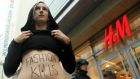 An activist protests against working conditions at production sites used by the H&M clothing chain in Bangladesh in Berlin last summer. Photograph: Getty Images