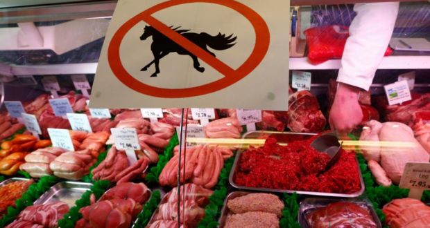 A butcher  works behind a “no horsemeat” sign  in Market Harborough, central England. Photograph: Reuters 