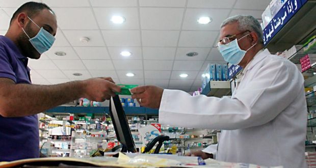A man, wearing a surgical mask as a precautionary measure against the novel coronavirus, pays for medicine at a hospital pharmacy in Khobar city in Dammam. Photograph: Reuters/Stringer (Saudi Arabia) 