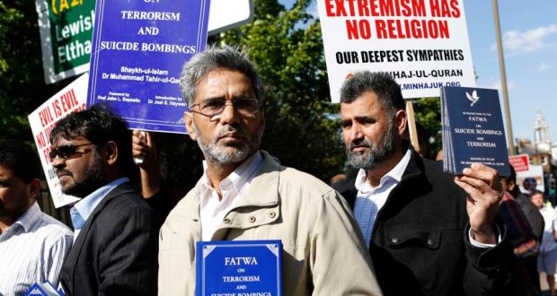 Members of Muslim group Minhaj-ul-Quran hold up books that call for a fatwa against suicide bombers, near the scene of the murder of British soldier Lee Rigby in Woolwich, southeast London. Photograph: Olivia Harris/Reuters