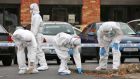 Members of the Garda crime scene investigation team examine the scene at St Dominick’s Road, Tallaght, yesterday  where a man was shot outside a gym. Photograph: Colin Keegan/Collins Dublin