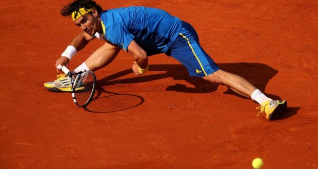 Fabio Fognini of Italy stretches to play a forehand against Rafael Nadal of Spain on day seven of the French Open at Roland Garros in Paris. Photograph:  Clive Brunskill/Getty Images