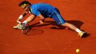 Fabio Fognini of Italy stretches to play a forehand against Rafael Nadal of Spain on day seven of the French Open at Roland Garros in Paris. Photograph:  Clive Brunskill/Getty Images