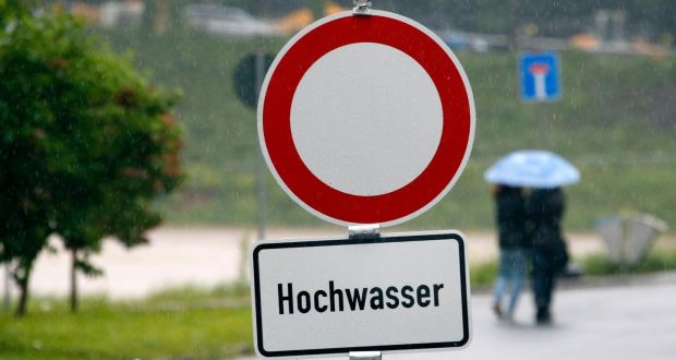 A sign warns of floods as rainfall continues  near inundated streets in the town of Grimma, near Leipzig, Germany. Authorities in the  state of Saxon have declared Grimma a disaster area, according to local media. Photograph: Fabrizio Bensch/Reuters