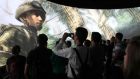 People watch a demonstration of Call of Duty at the Activision exhibit at E3, the Electronic Entertainment Expo, in Los Angeles, California