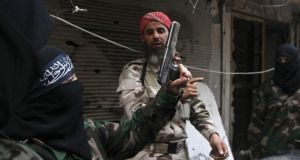 A female member of the Ahbab Al-Mustafa Battalion holds a gun as she undergoes military training in Aleppo’s Salaheddine district. Photograph: Muzaffar Salman/Reuters