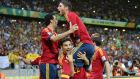 Spain’s Jesus Navas (bottom) celebrates with his teammates after scoring the winning penalty  against Italy in the  shoot-out of their Confederations Cup semi-final  at the Estadio Castelao.