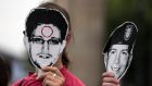 People hold portraits of former US spy agency contractor Edward Snowden (left) and US Army Private  Bradley Manning, a suspected whistleblower who is on trial in the US for “aiding the enemy”,  during a protest in front the Brandenburg Gate in Berlin. Photograph: Thomas Peter/Reuters