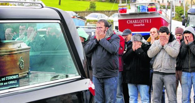 Egyptian colleagues grieve behind a hearse containing the body of Tit Bonhomme crew member Attia Shaban at the pier at Union Hall in west Cork, after the trawler sank early last year. Photograph: Julien Behal/PA Wire