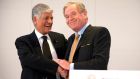 Maurice Levy, chief executive officer of Publicis Groupe SA and John Wren, chief executive officer of Omnicom Group Inc., shake hands after signing the merger deal in Paris yesterday.
